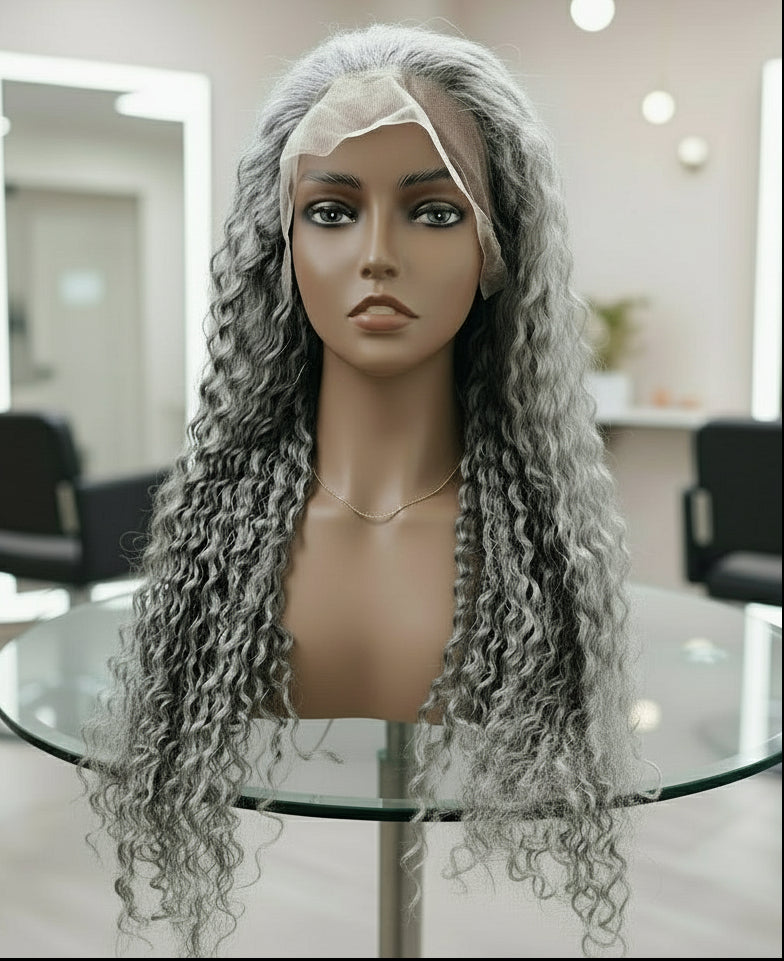 Front view of a Mannequin head displaying NuHaire's Silver Grey Deep Curly Transparent Lace Front Human Hair Wig, featuring a natural silver grey hair color, premium quality human hair, a bouncy deep curly texture, and a 13x6 transparent lace front.