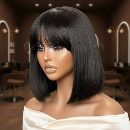 Closer view of mannequin head showcasing the NuHaire Yaki Straight Human Hair Bob with Bangs, featuring a natural black color, premium quality human hair, glueless installation, light yaki straight texture, double-drawn ends, and bangs.