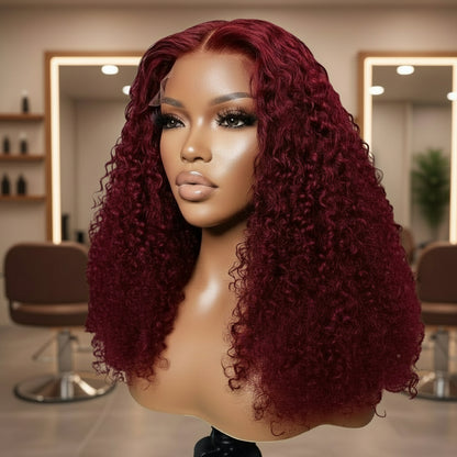 Different view of a mannequin head showcasing the NuHaire 99J Burgundy Kinky Curly 5*5 /13*4 Transparent Lace Human Hair Wig, featuring a rich burgundy color, premium quality grade human hair, transparent lace front, natural hairline, and bouncy kinky curly texture.