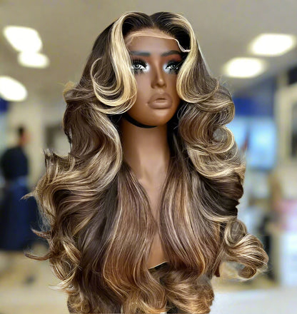 13x4 Transparent lace front human hair wig displayed on a mannequin head showing full 250% density volume, rich bronde highlight, natural hairline, long cascading waves, European human hair, and body wave texture with blurred background