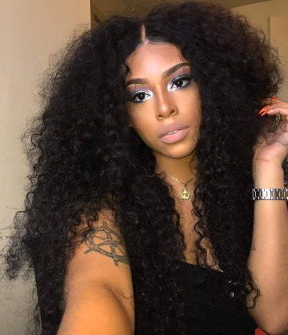 A person wearing NuHaire's kinky curly 13x6 lace front wig with a pre-plucked, pre-bleached hairline. The wig features a natural black color, full 250% density, and skin-melt HD lace.