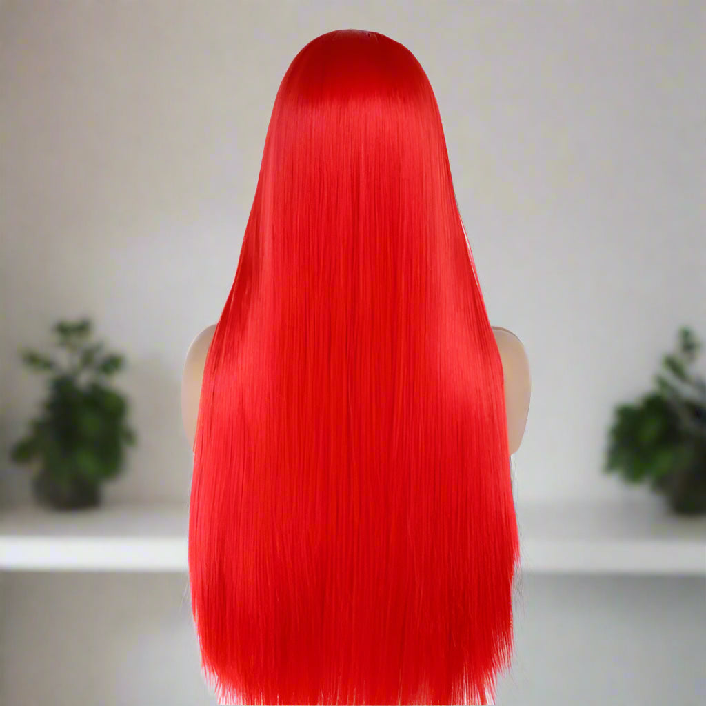 Red wig on a mannequin head against a white background