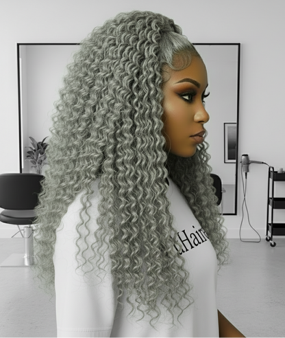 Side view of a Model showcasing NuHaire's Silver Grey Deep Curly Transparent Lace Front Human Hair Wig, featuring a natural silver grey hair color, premium quality human hair, a bouncy deep curly texture, and a 13x6 transparent lace front.