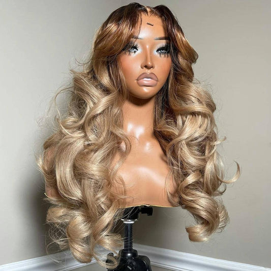 A mannequin displays NuHaire's Rooted Ash Blonde Balayage| 13x4 Body Wave, featuring a dark root that transitions to ash blonde highlights. This high-quality human hair wig offers a full 250% density, body wave texture, 13x4 lace front, and a transparent lace for a natural hairline